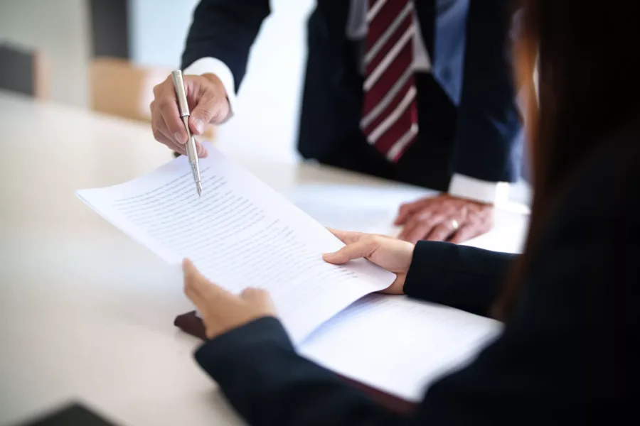 Lawyer with lawsuit meeting with client discussing with contract agreement at courtroom